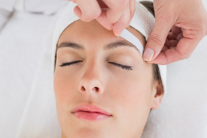 lading having her eyebrow waxed