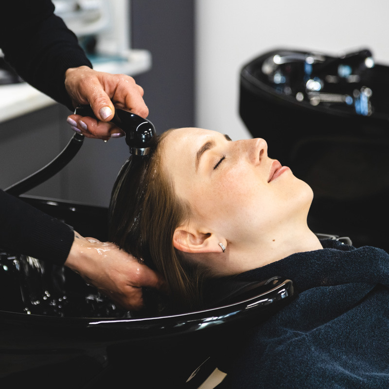 women getting hair rinsed during haircut